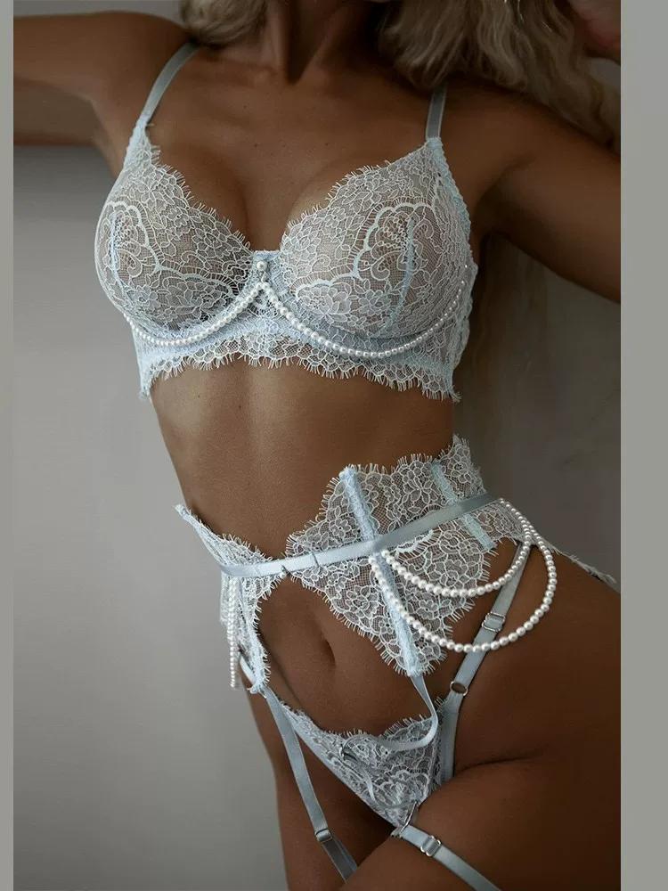 full-body view of white 4-piece lace garter lingerie set showing bralette, garter belt, lace thong, and elastic leg bands