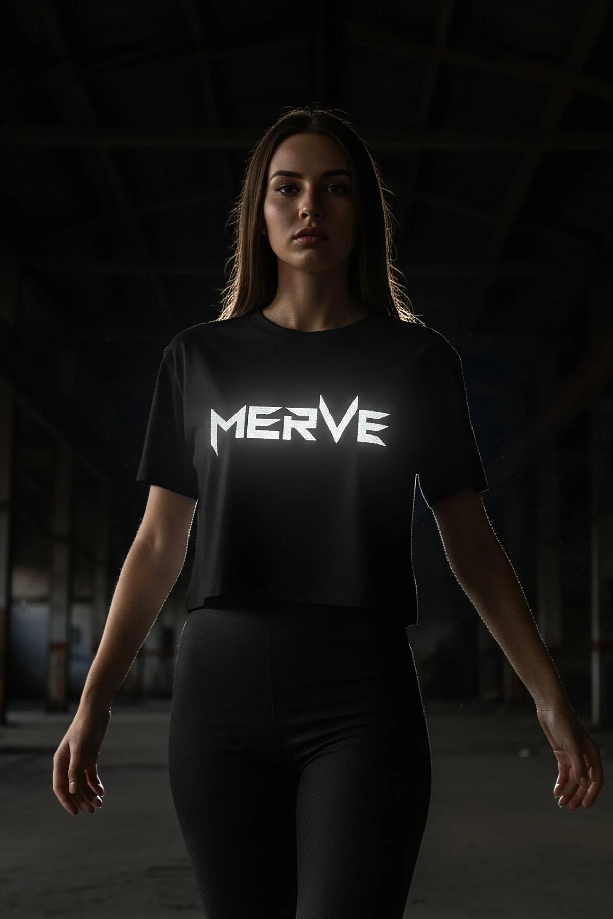 Black crop t-shirt with large silver reflective graphic lettering on chest worn with black leggings