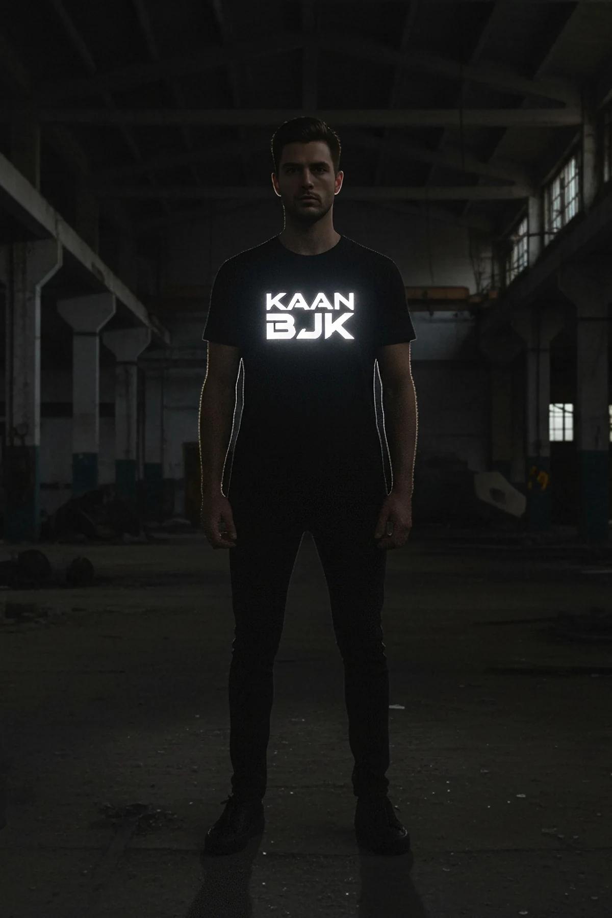 front view black oversized cotton tee with reflective chest graphic activated under direct light