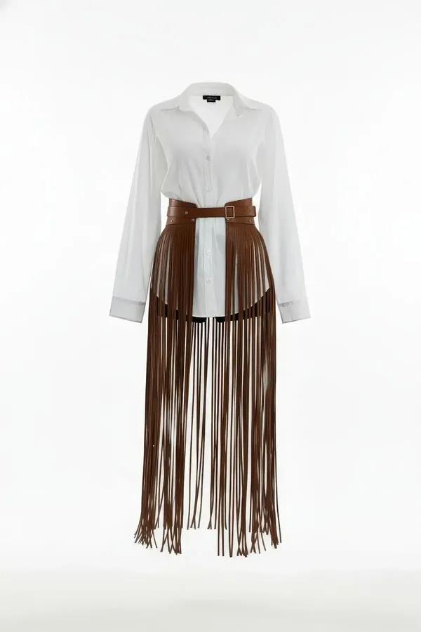 Brown faux leather fringe overlay belt with long cascading tassels and adjustable silver pin-buckle waistband worn over white