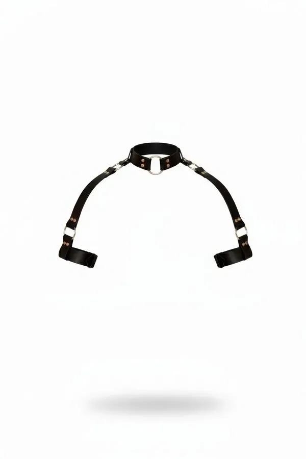 Black faux leather collar harness with silver O-ring and wide arm cuff straps, product flat lay on white background