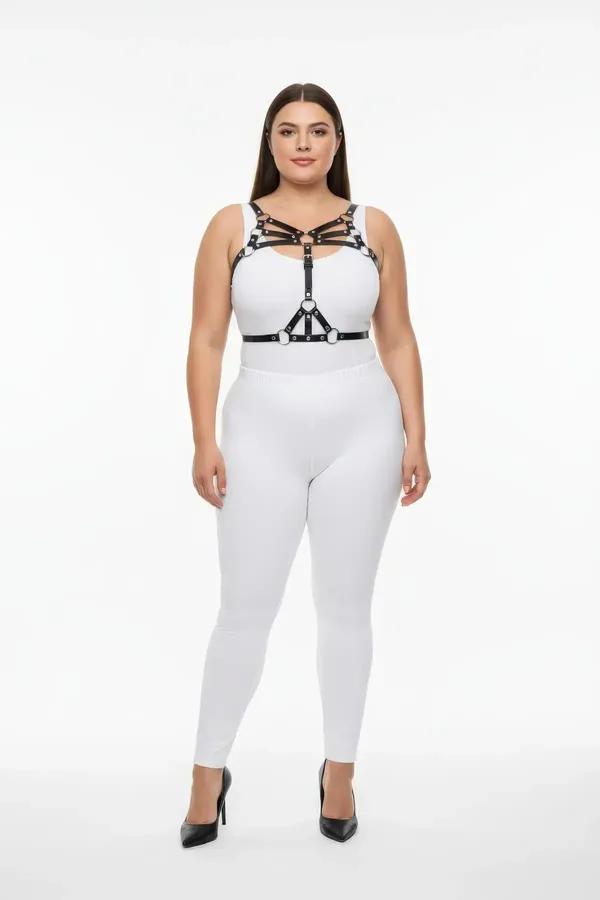 Black multi-strap chest harness with silver O-ring accents worn over white bodysuit front view