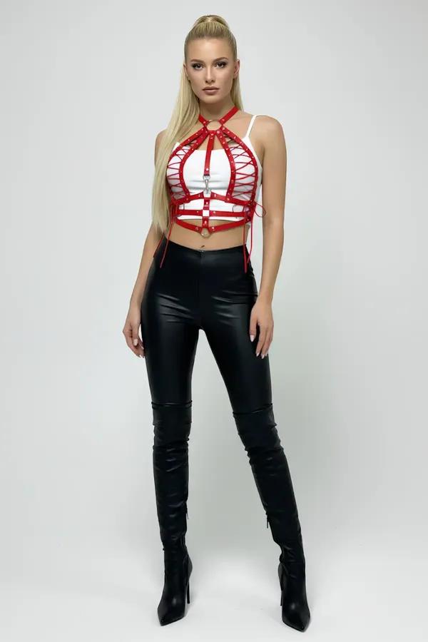 Red faux leather laced halter body harness top with silver O-rings and crisscross chest strap lacing worn over white crop top