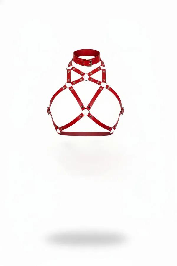 Red faux leather collar body harness with crossed O-ring chest straps and silver rivets on white background