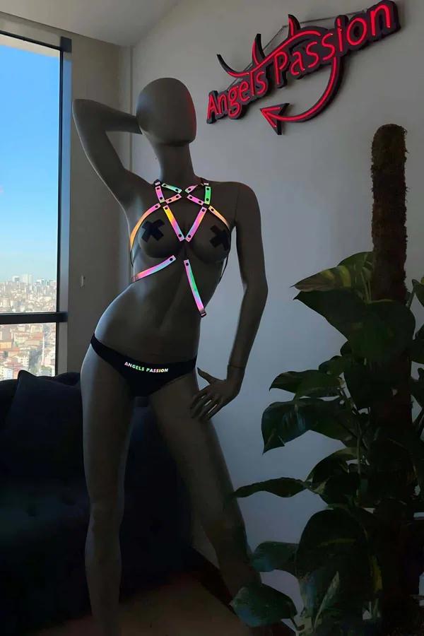 Rainbow reflective body harness with iridescent holographic cage straps and silver square hardware on mannequin