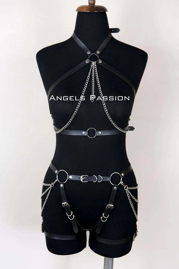 Black faux leather full body harness with silver chain draping, O-rings, and adjustable buckle thigh straps on mannequin