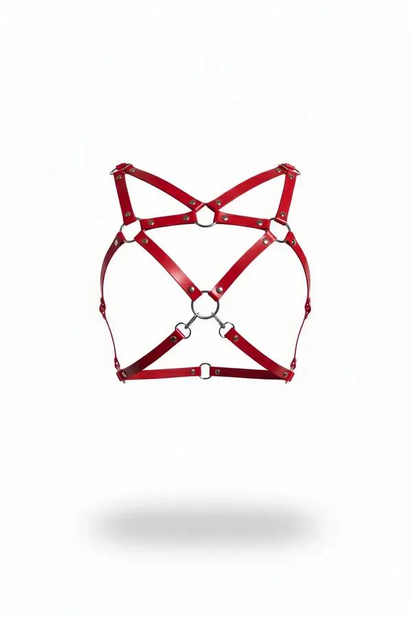 Red faux leather chest harness with crossing X-straps and silver O-rings on white background