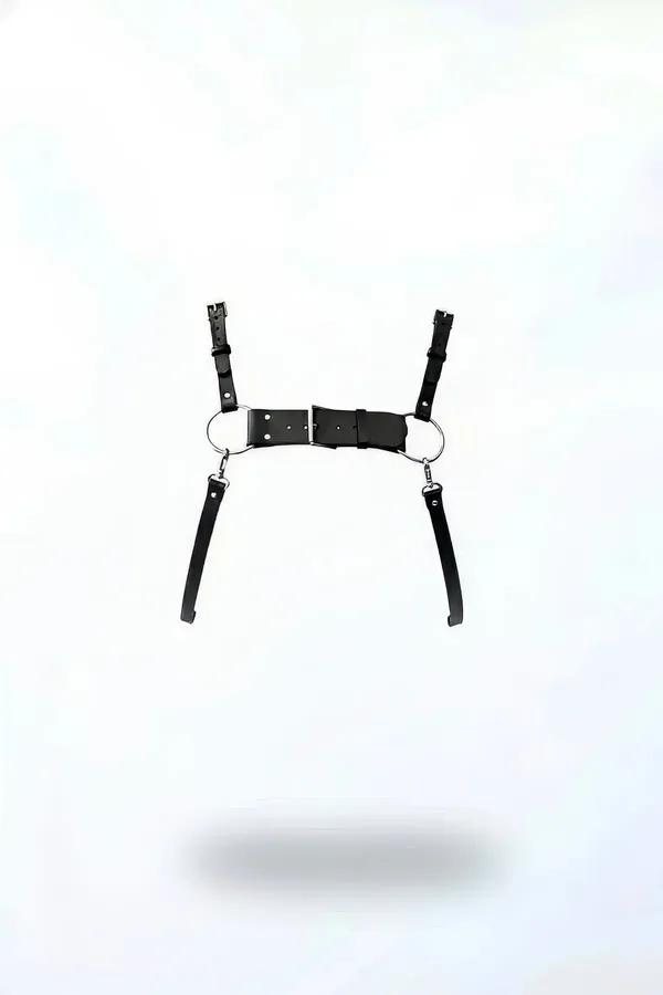 Black faux leather underbust harness with dual silver O-rings and four adjustable buckle straps, flat lay on white background