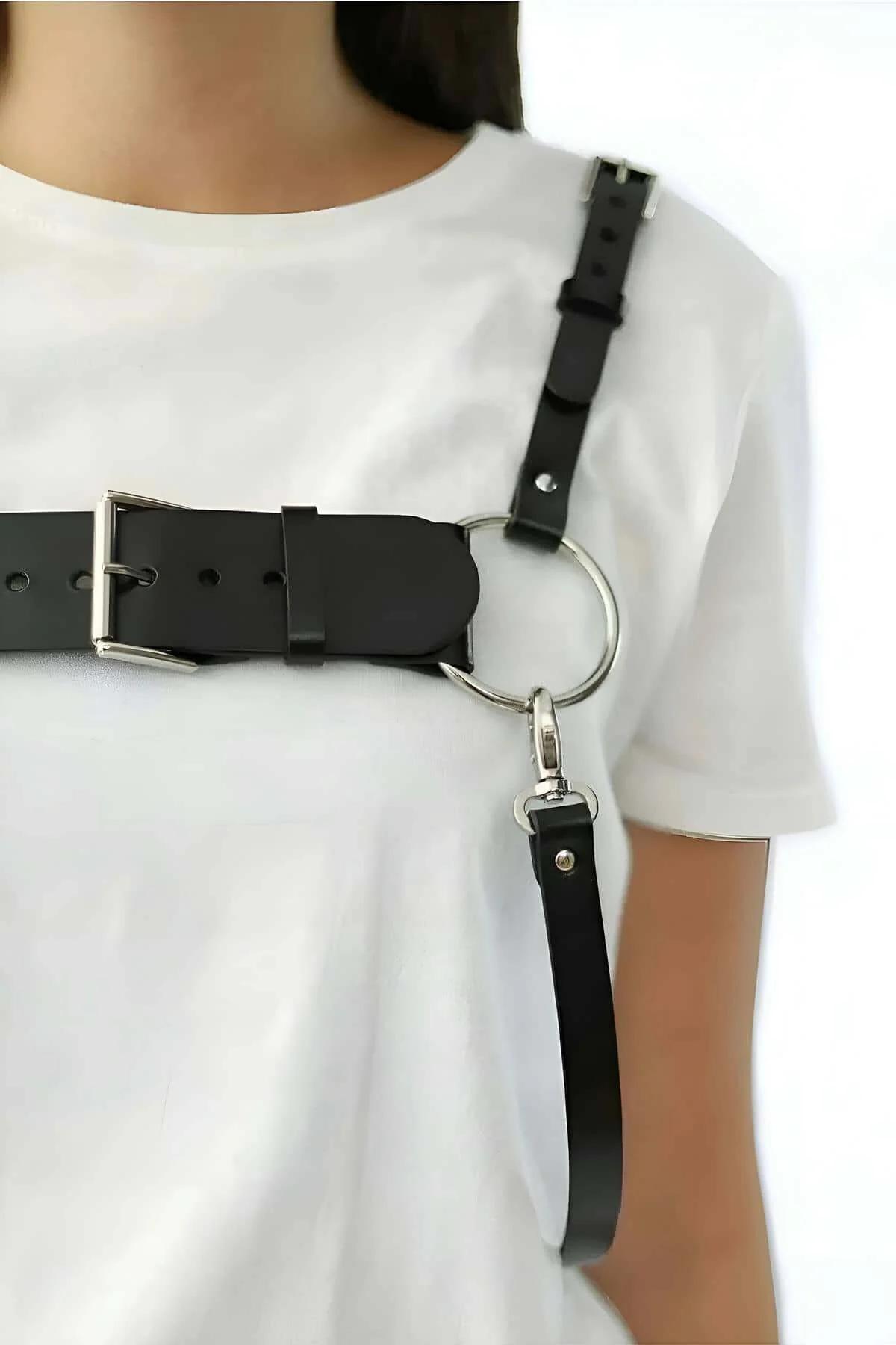 Black vegan leather chest harness laid flat showing full strap configuration and hardware detail