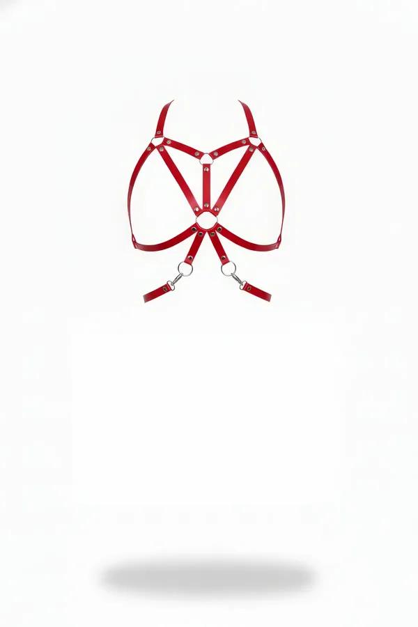 Red faux leather caged harness bra with silver O-rings and geometric crossing straps on white background