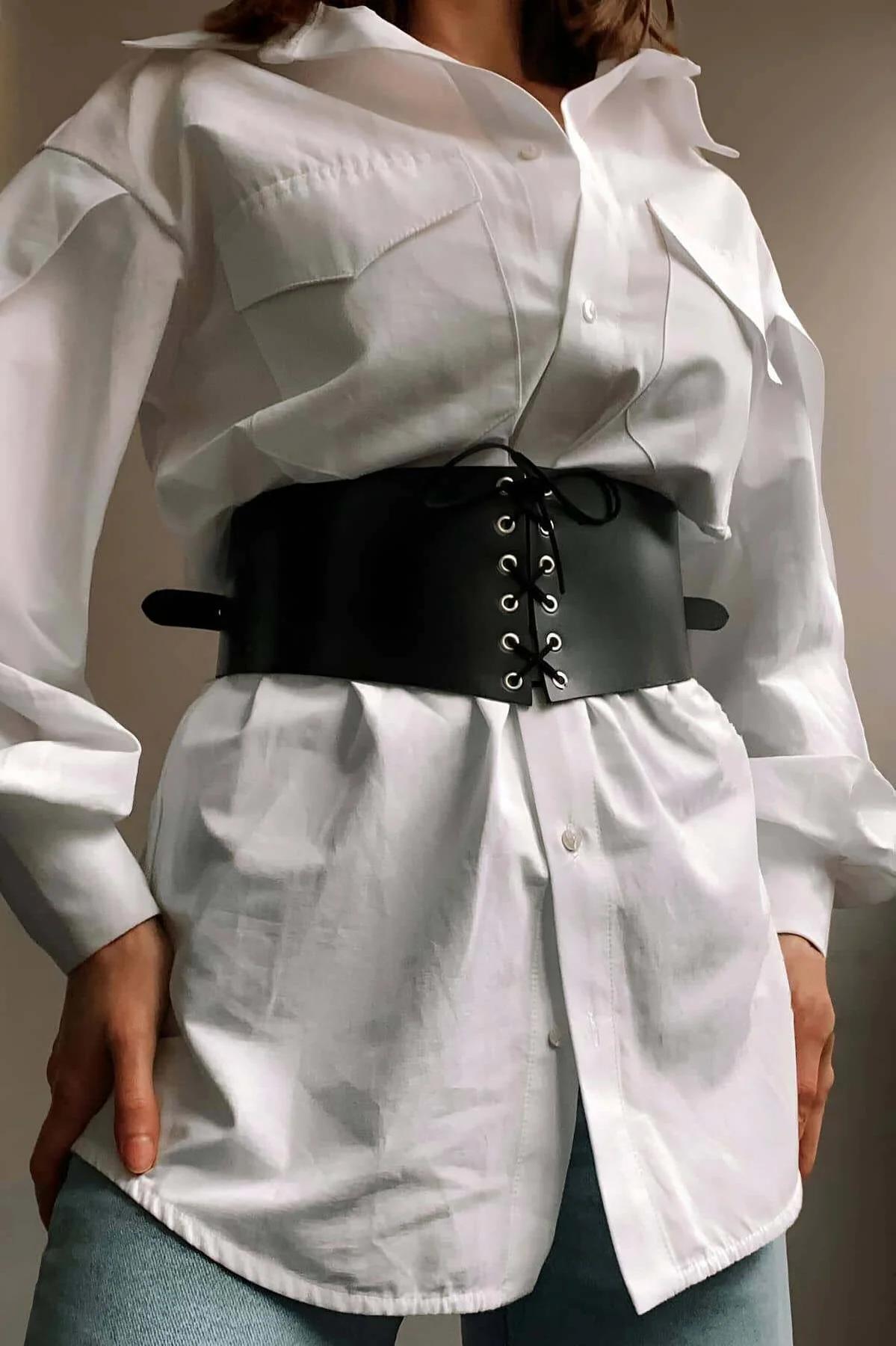 black faux leather wide waist cincher belt with silver eyelet corset lacing worn over white shirt