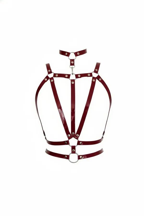 Burgundy patent faux leather multi-strap body harness with silver O-rings and rivet studs on white background