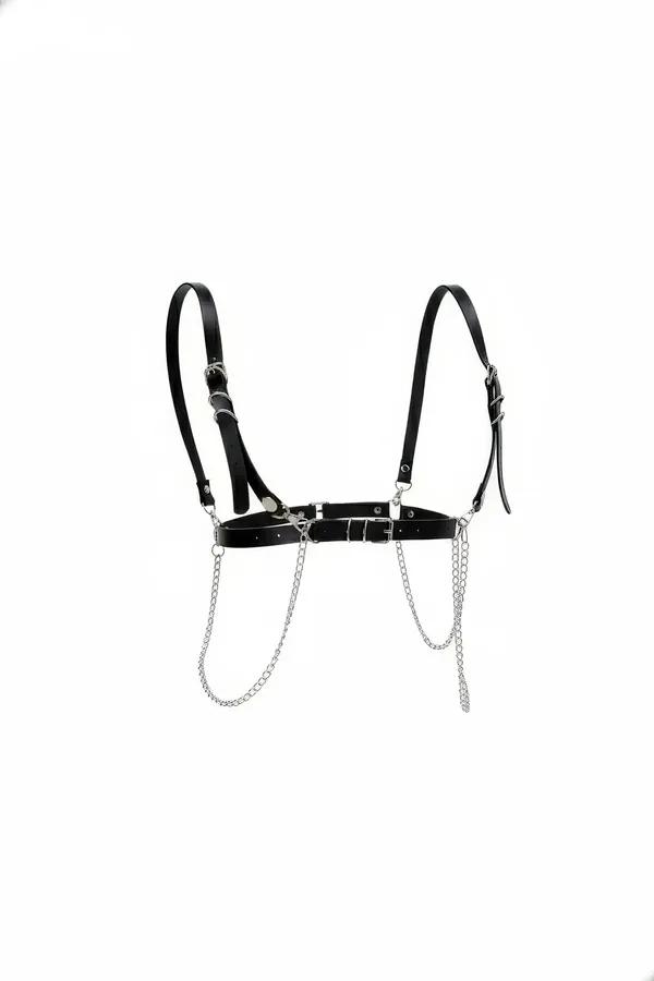 Black faux leather chest harness with cascading silver draping chains and adjustable buckle straps on white background