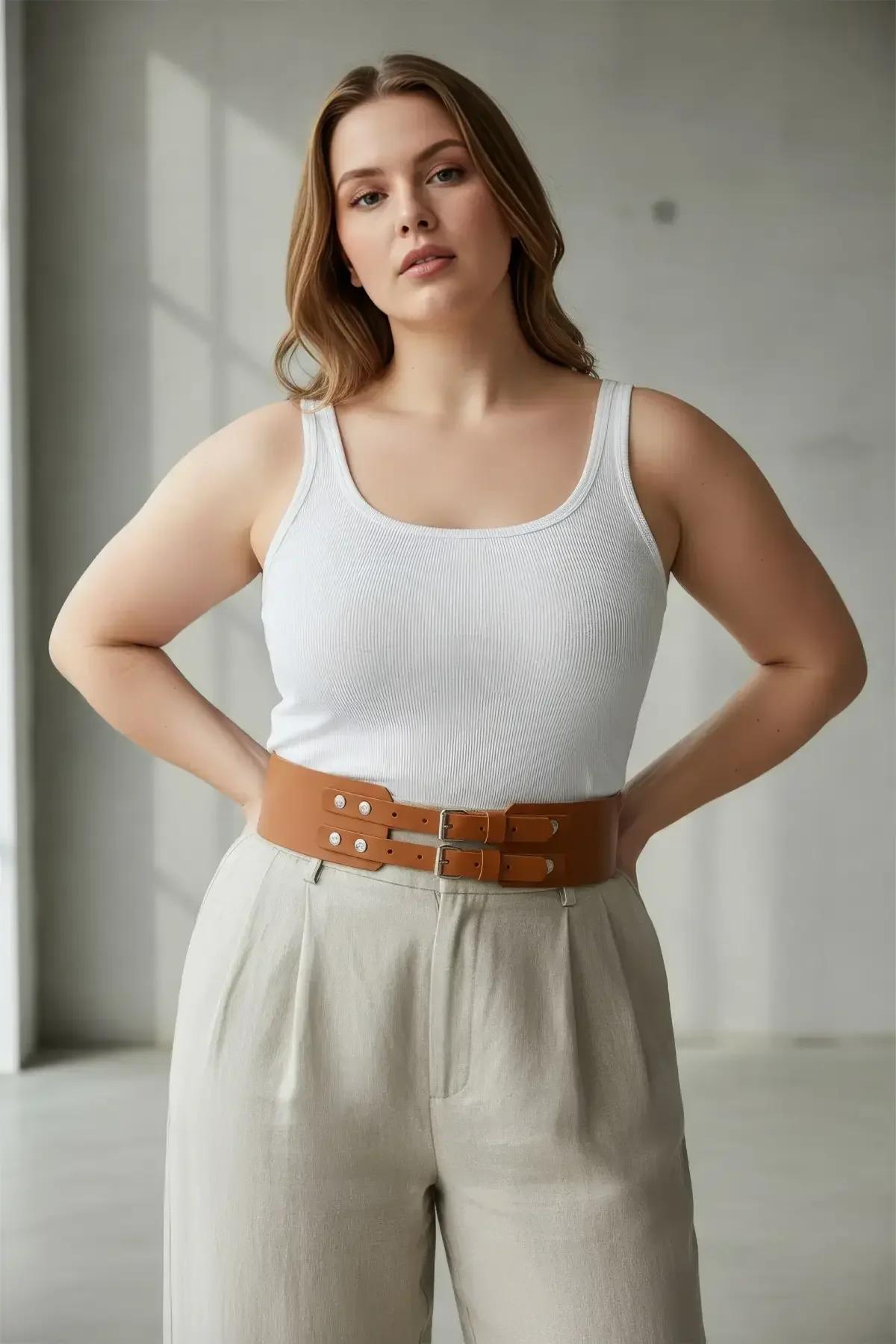 Wide structured corset belt in tan brown faux leather with silver-tone hardware detail closeup