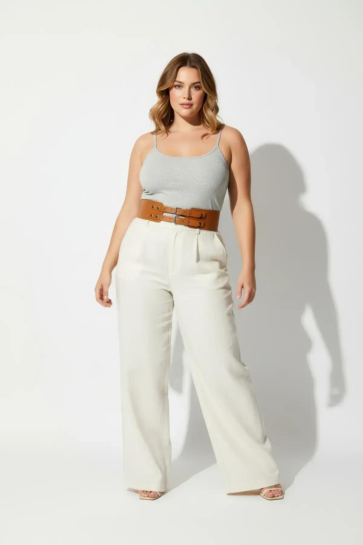 Tan corset belt styling over white top and wide-leg trousers full length outfit view
