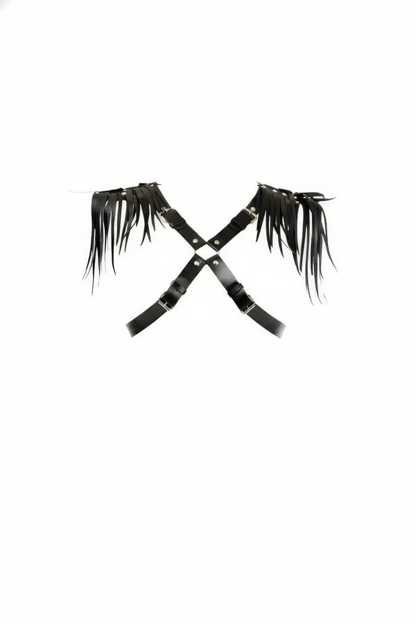 black faux leather cross body harness with shoulder fringe panels and silver buckle hardware flat lay