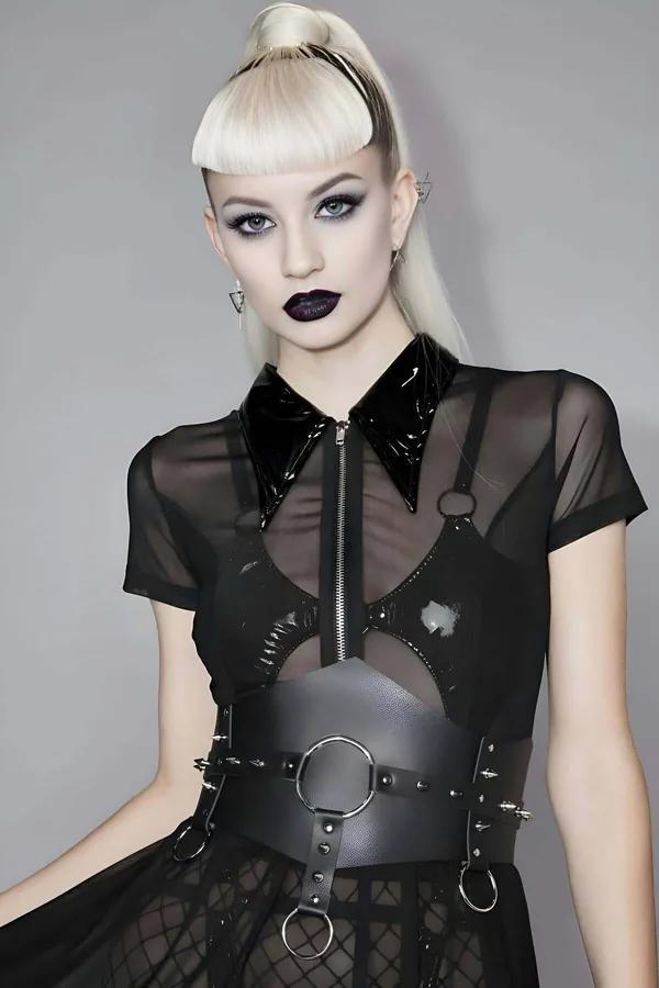 Black faux leather spiked O-ring waist and chest harness with silver rivets and dual metal O-rings worn over sheer mesh top
