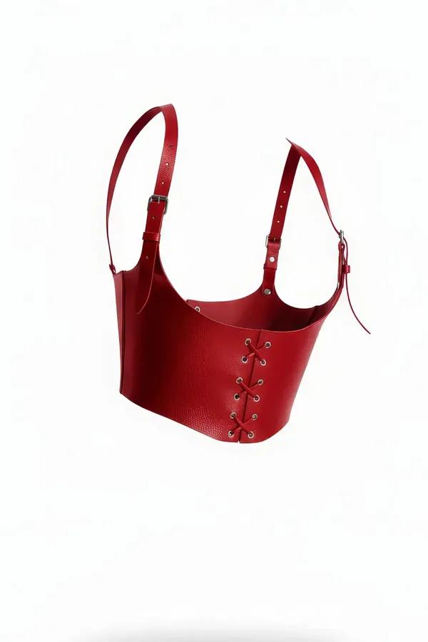 Red pebble-grain faux leather corset harness with silver grommet lace-up front and adjustable buckle shoulder straps