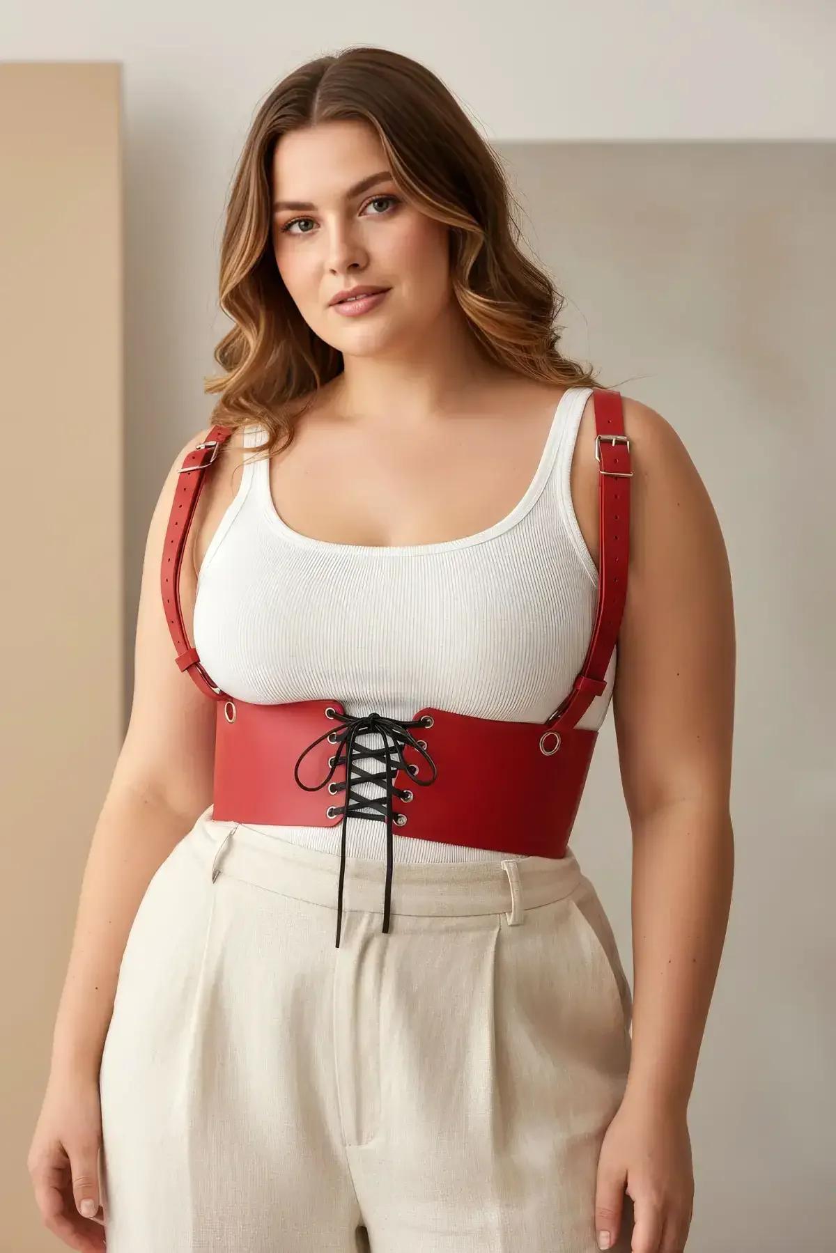 side view of red PU faux leather underbust harness showing shoulder strap pin buckle detail