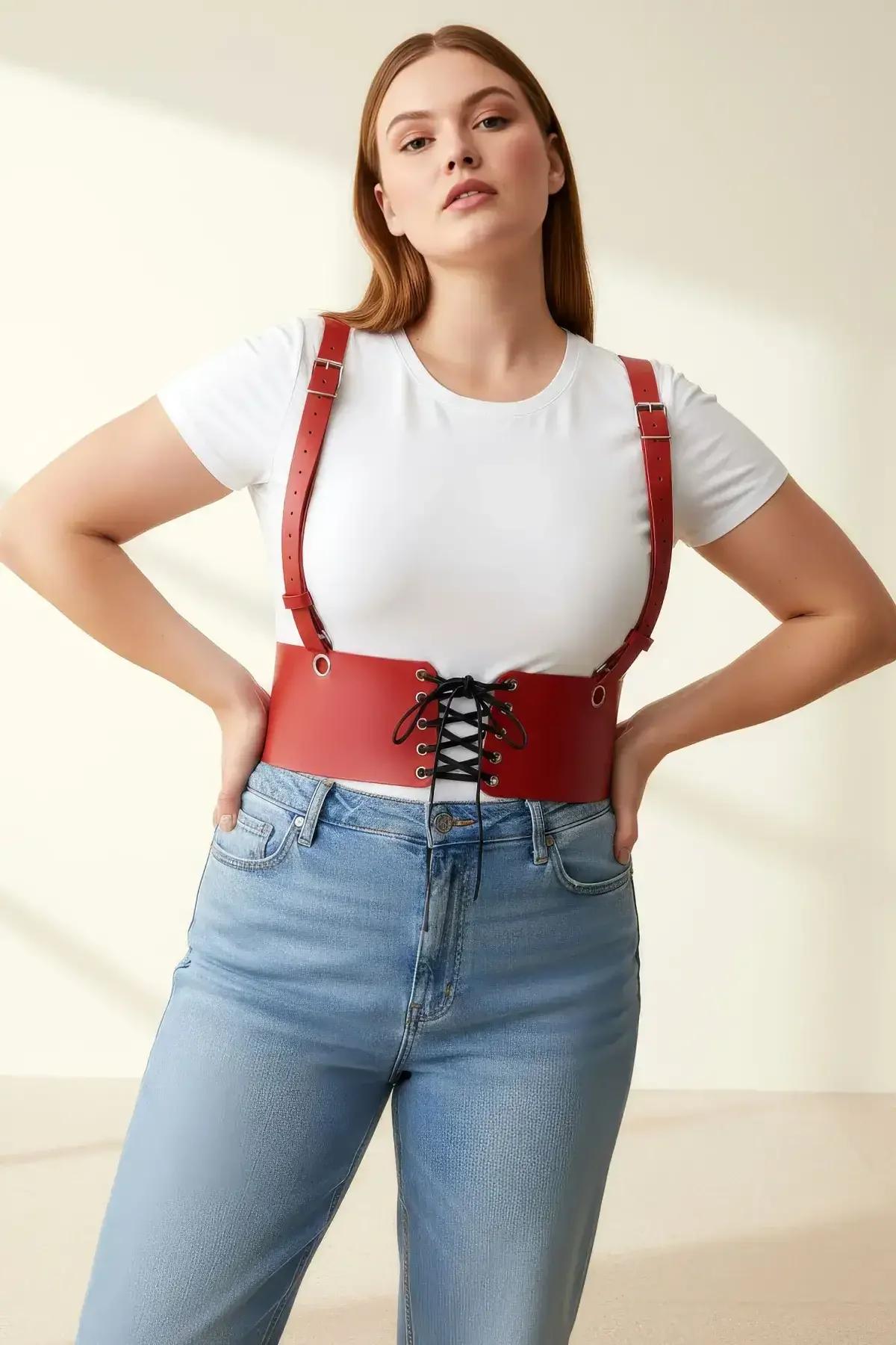 red underbust fashion harness styled over white tank top and beige wide-leg trousers full length view