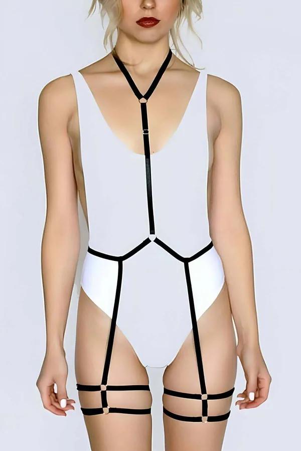 Black elastic full body harness with halter neck Y-strap, geometric waist cage, and thigh cage bands with gold O-ring hardwar