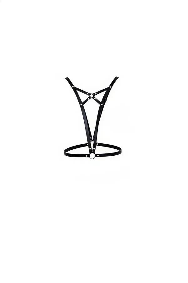 Black faux leather V-strap chest harness with silver O-ring waist band and rivet hardware, flat lay