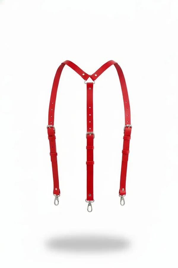 Red faux leather Y-back suspender harness with silver lobster clips and pin buckles on white background