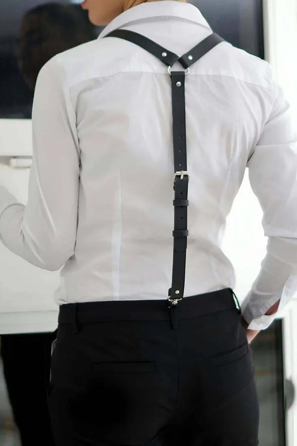 Black faux leather suspenders harness Y-back silver buckle rivet detail worn over white shirt