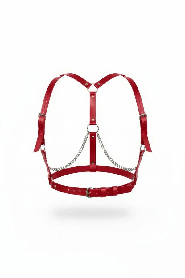 Red faux leather body harness with draped silver O-ring chains and rectangular buckle closure, front view