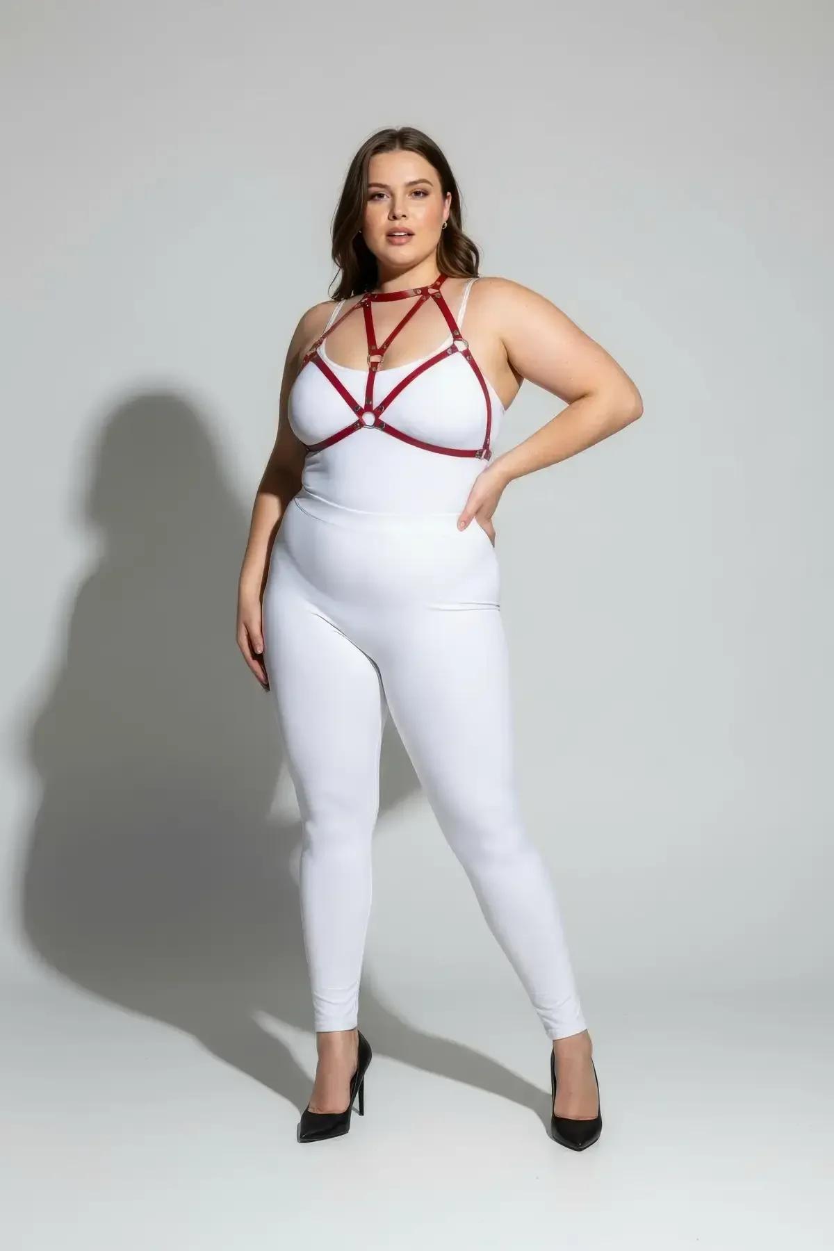 Red strappy chest harness geometric cage pattern detail against neutral background