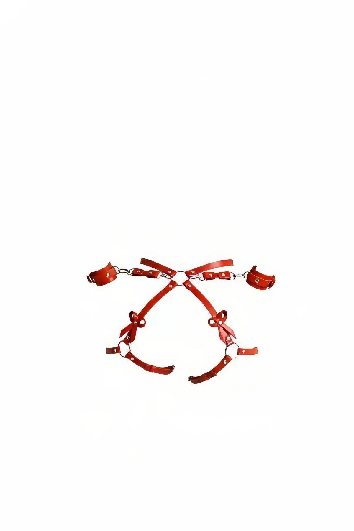 red faux leather chest harness set with detachable wrist cuffs and silver O-ring hardware, flat lay