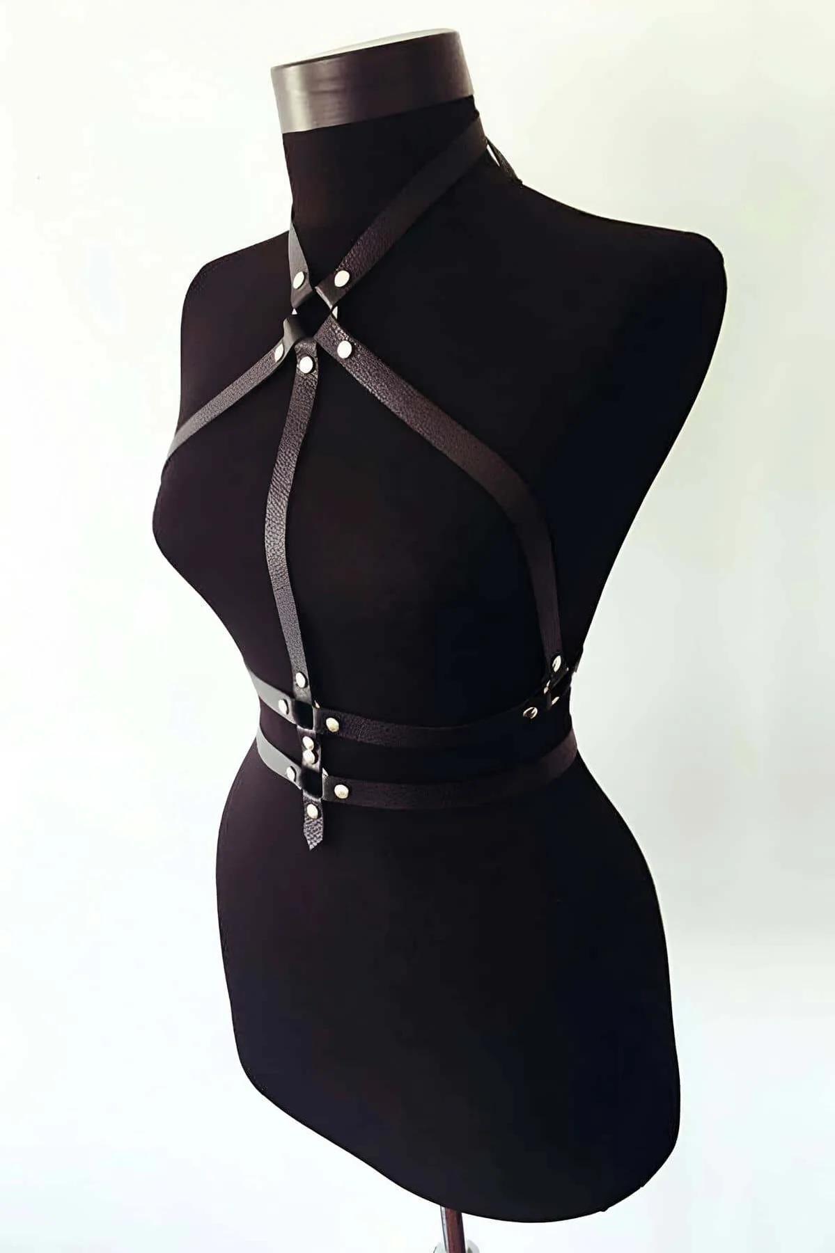 close-up of silver rivet hardware on black vegan leather crossed chest straps