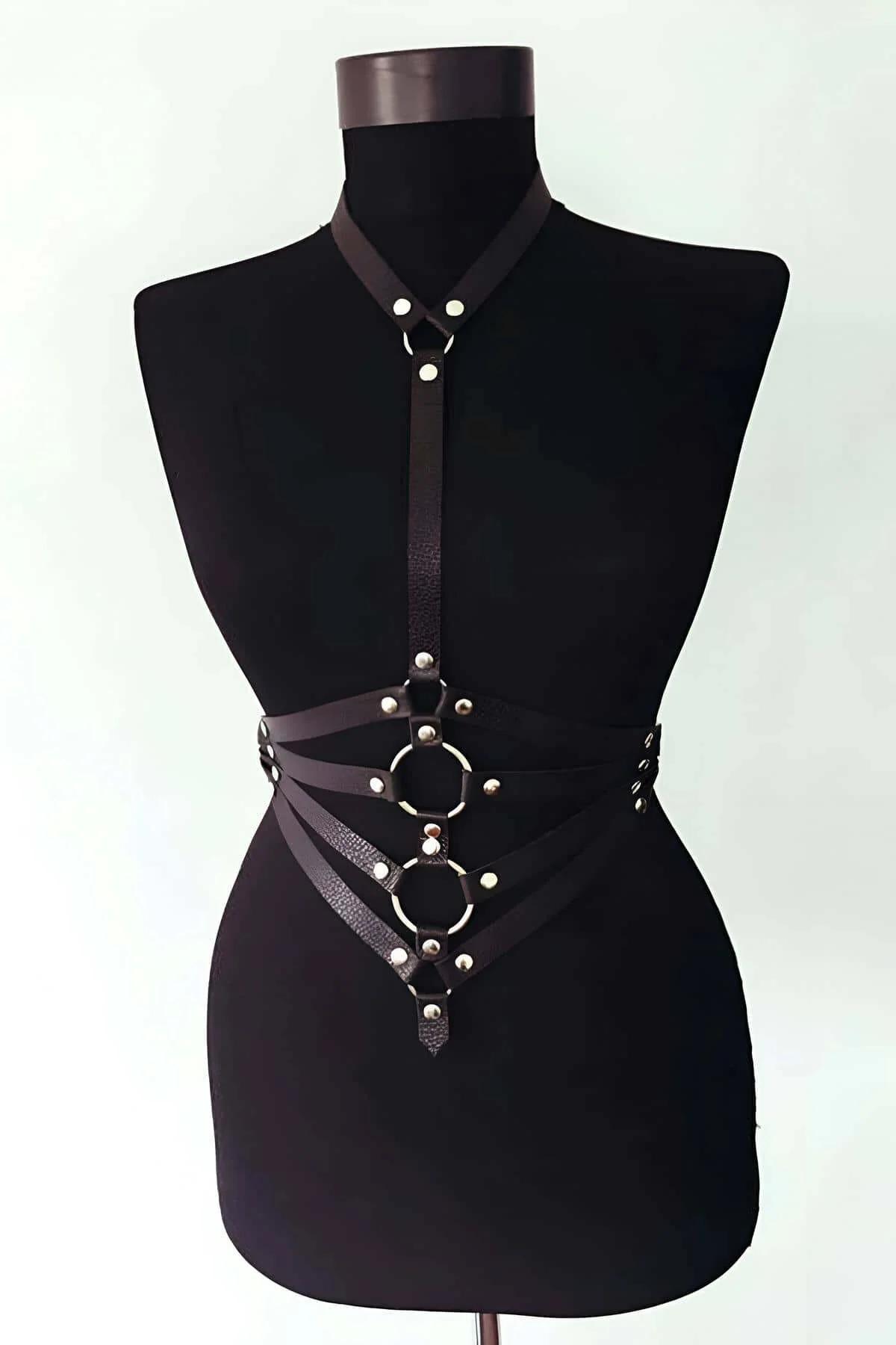 Close-up of three stacked octagonal O-rings on black vegan leather center strap with silver rivets