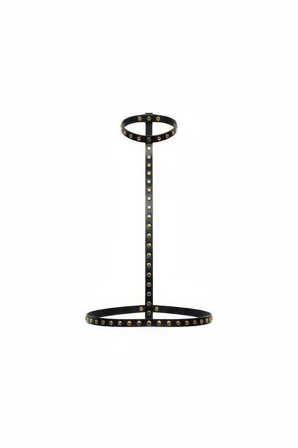 Black faux leather studded body harness with brass-tone studs, collar ring, vertical strap, and wide waist band on white back