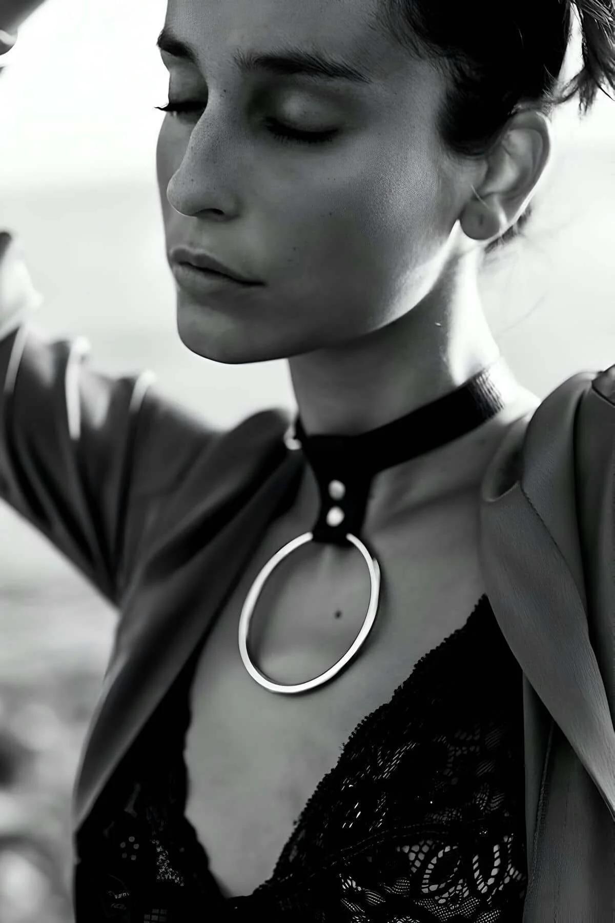 black vegan leather O-ring choker worn against bare neck showing adjustable fit