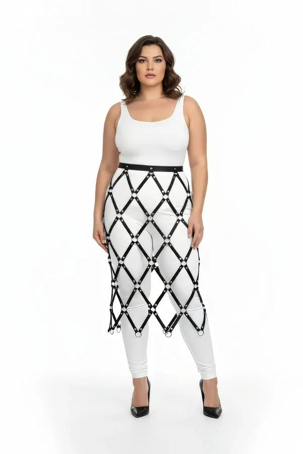Black faux leather diamond lattice skirt harness with silver O-rings at strap intersections worn over white leggings