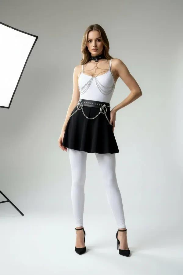 black faux leather choker body chain and O-ring waist belt set with silver draping chains worn over white bodysuit
