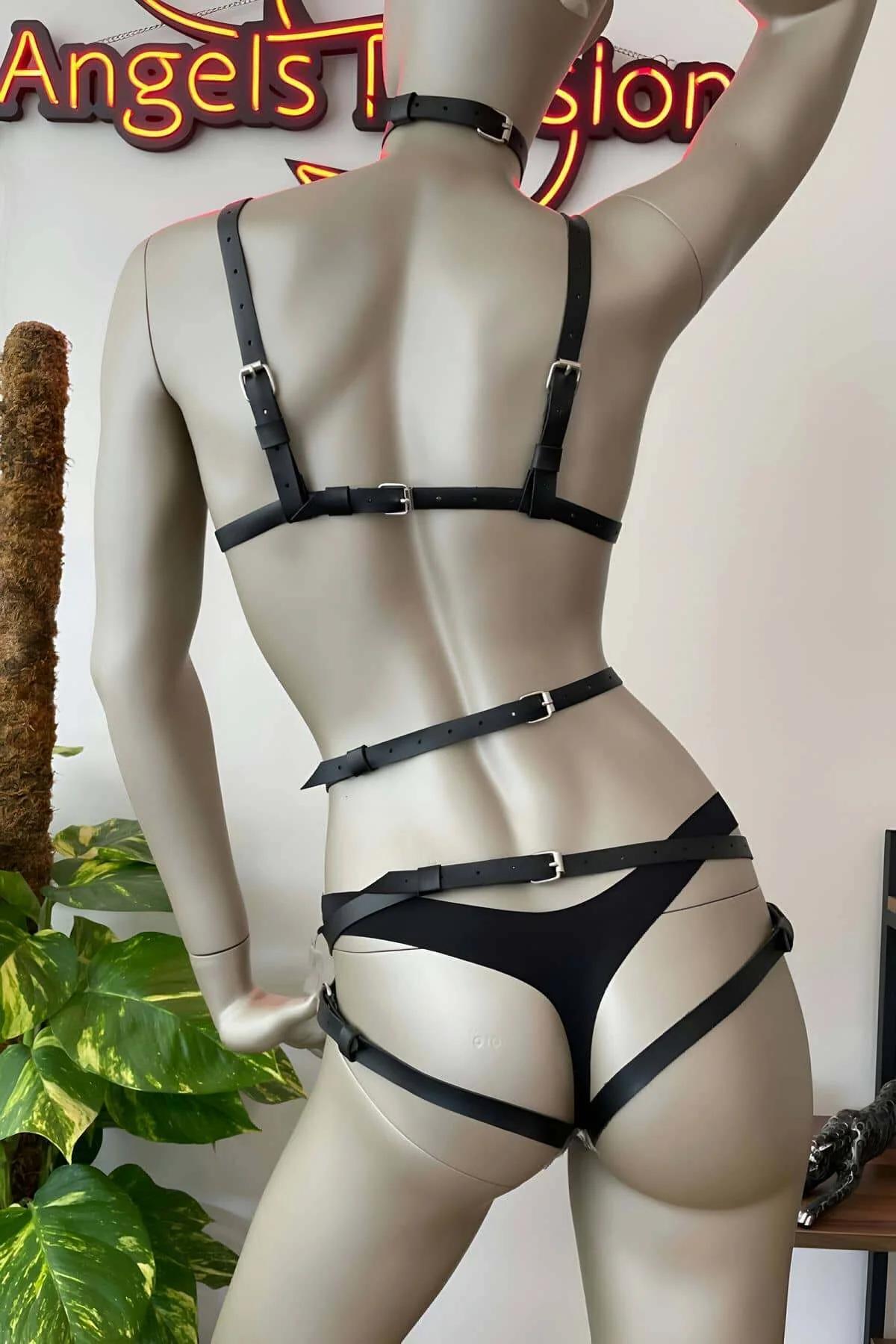 Black PU leather chest harness with heart-shaped patches and silver dome studs front view