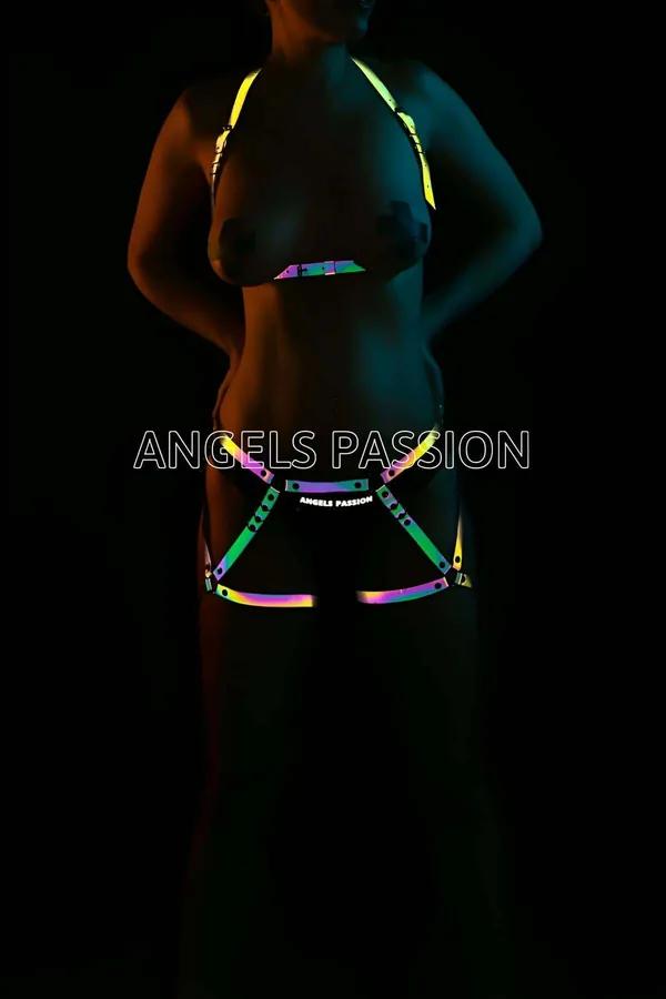 Iridescent rainbow reflective body harness set glowing green yellow pink teal on dark background, two-piece chest and waist h