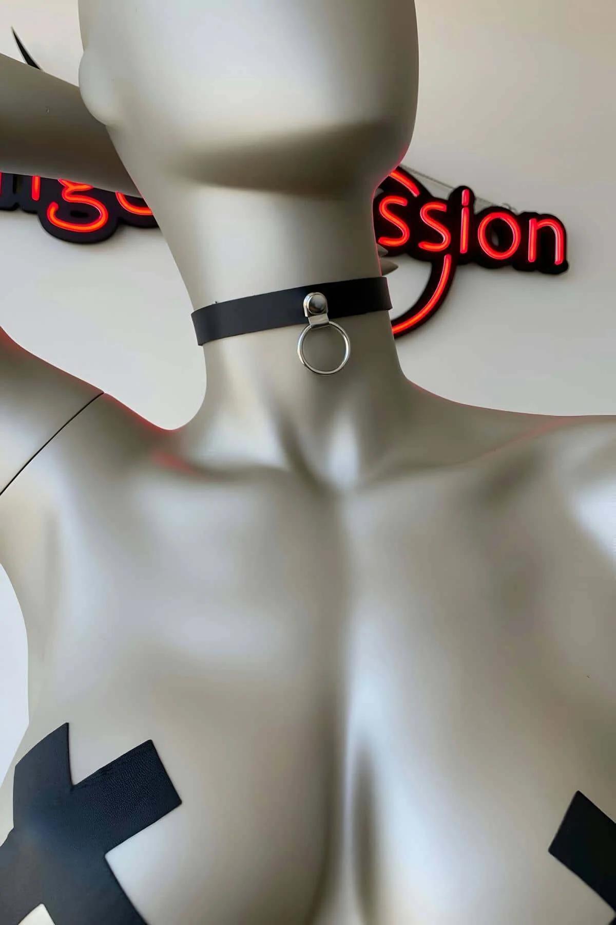 black faux leather choker necklace with silver O-ring front rivet on mannequin, matte band 2.5 cm wide