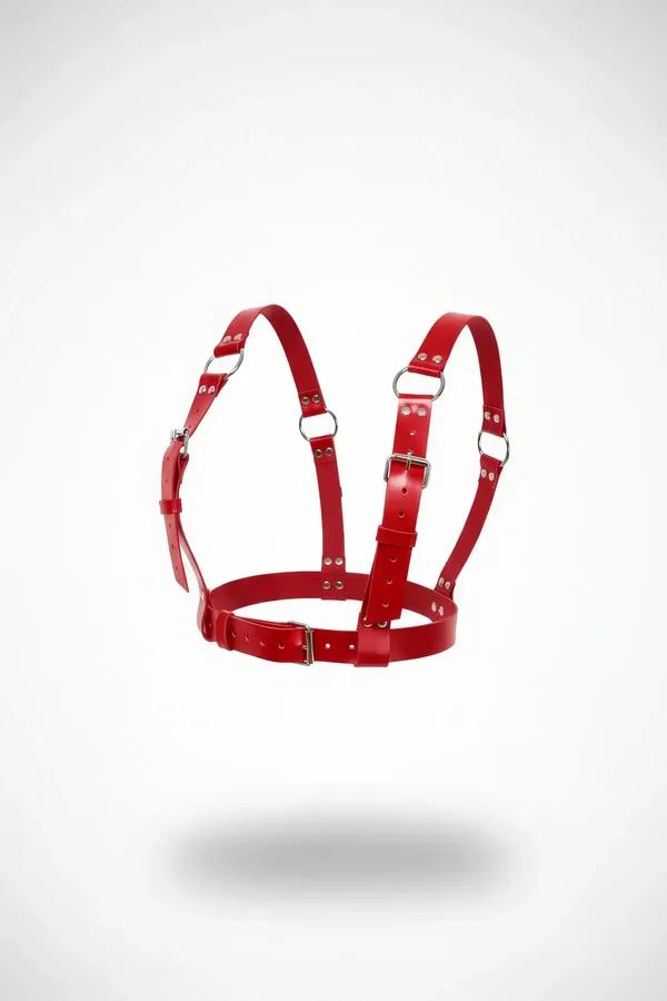 Red faux leather adjustable chest harness with silver O-rings and roller buckles, structured cage silhouette