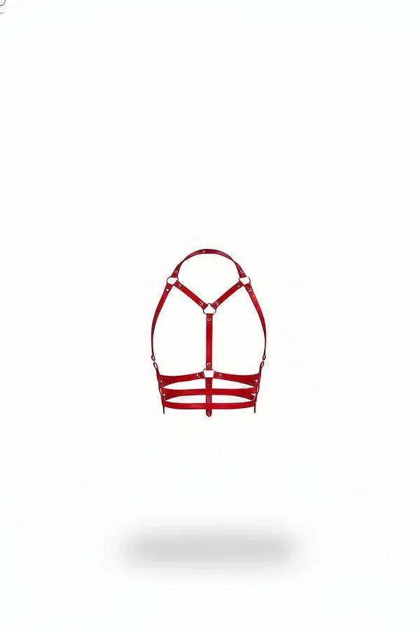 Red faux leather underbust cage harness with gold O-ring hardware and three horizontal strap bands, front view on white backg