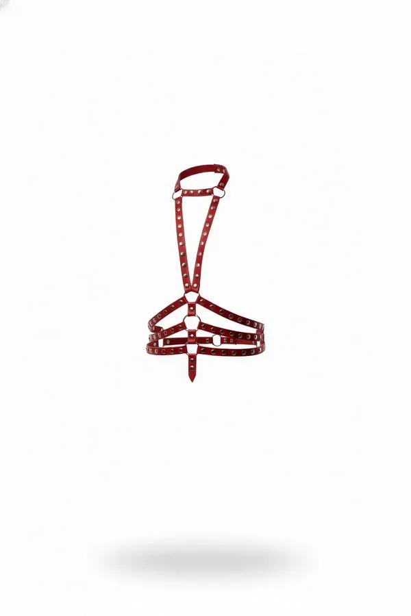 Red studded faux leather chest harness with silver O-rings and double horizontal chest bands on white background