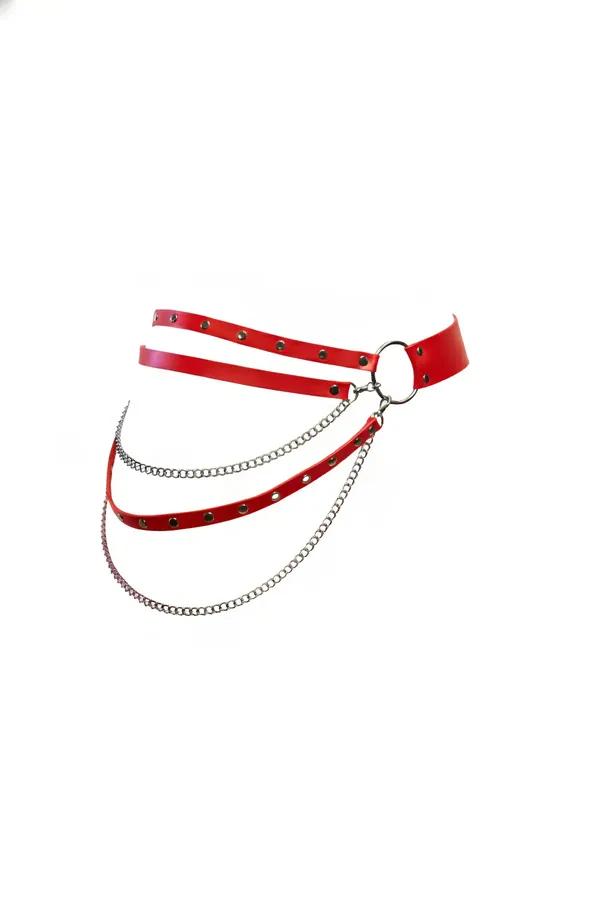 Red faux leather waist harness with silver O-ring and three layered draped chains on white background