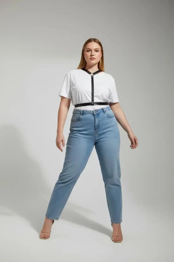 Black faux leather Y-strap chest harness with silver O-ring worn over white t-shirt and light blue jeans