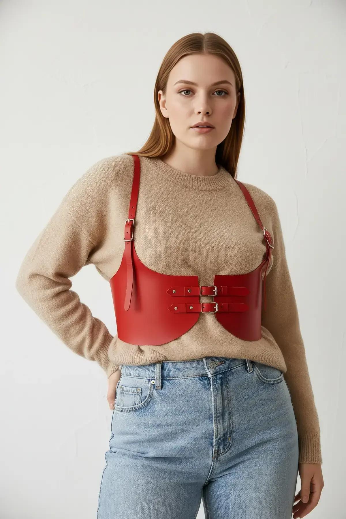 close-up of red faux leather corset harness dual buckle detail with silver-tone hardware