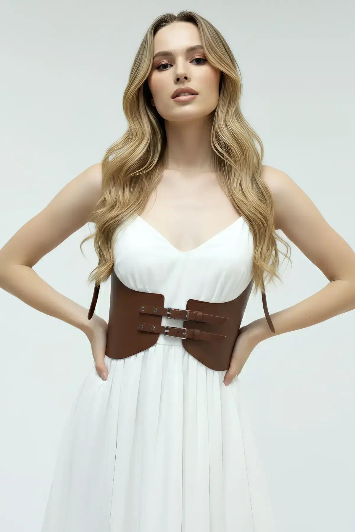 close-up of gold-tone double buckle closure on brown vegan leather underbust harness