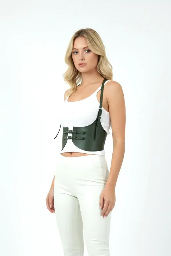 Forest green faux leather underbust harness corset with triple silver buckle straps and left shoulder strap worn over white t