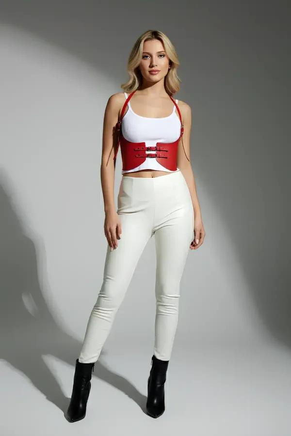 Red faux leather underbust cinch harness with double black buckles and adjustable halter straps worn over white top