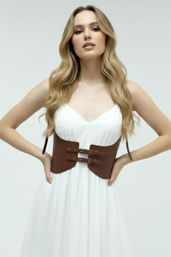 Wide chocolate brown faux leather underbust waist cinch belt with dual silver front buckles worn over white dress